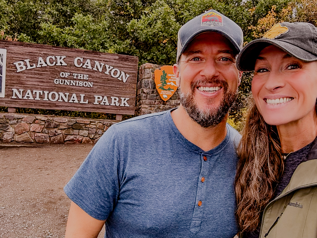 Lance & Carrie at Black Canyon Entrance Sign — Montrose, Colorado (2026)