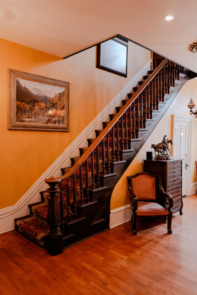 Grand Wooden Staircase & Red Floral Runner — Cimarron, New Mexico (2026)